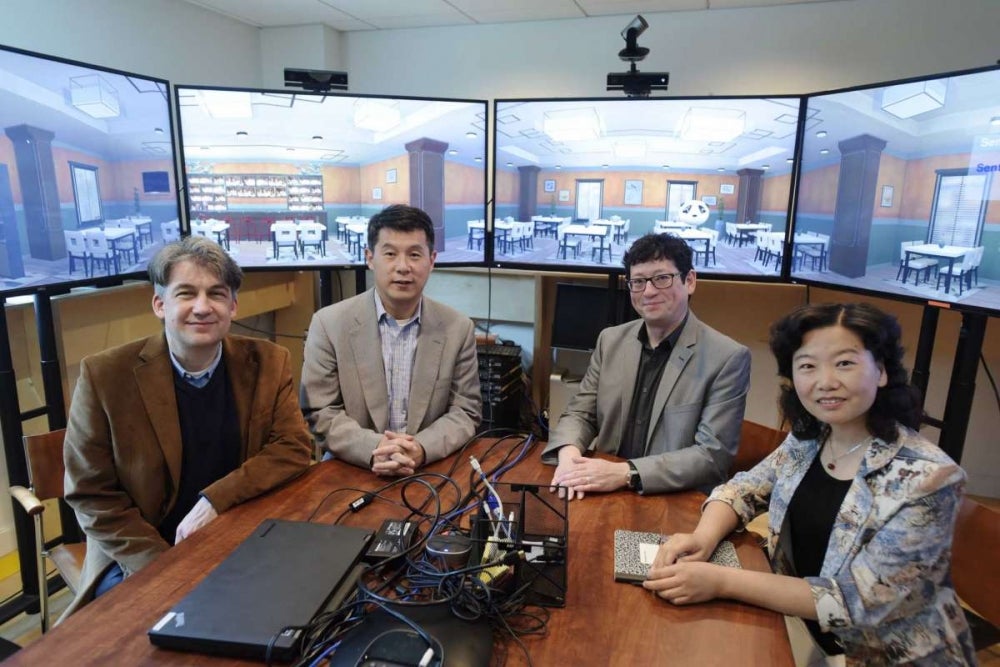 RPI professors, Jonas Braasch, left, associate director of CISL, Hui Su, second from left, director of CISL, Ben Chang, third from left, professor of arts, Games Simulation Arts and Sciences and Jianling Yue, Chinese lecturer, pose for a photo on Thursday, June 7, 2018, in Troy, N.Y. The four professors are working on the Mandarin Project